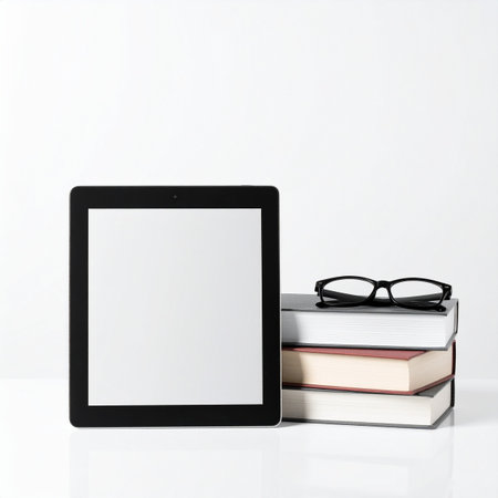 A modern e-reader with a blank screen stands ready for a new story, placed next to a classic stack of hardcover books and reading glasses.の素材