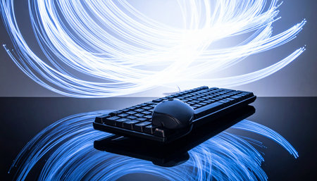 A sleek keyboard and mouse rest on a reflective surface, enveloped by dynamic swirls of blue and white light.の素材