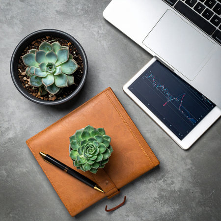 A top-down view of a modern professional's desk, where financial analysis meets natural calm.の素材