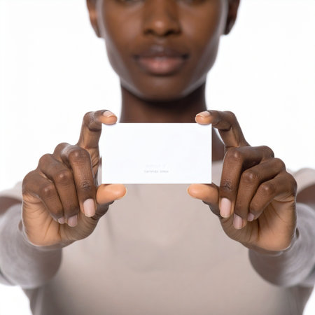 A professional woman holds a blank white card directly towards the viewer, offering a perfect template for a business card, ID, or important message.の素材