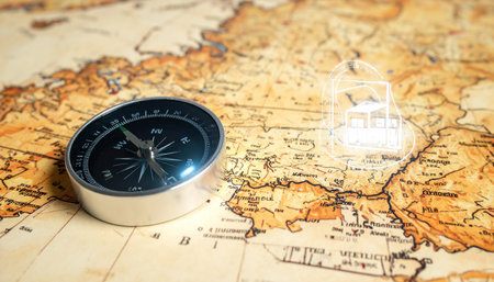 An old compass rests on a vintage world map, its needle steady, pointing towards a new adventure.の素材