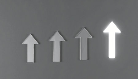 A single bright arrow stands out from the others, pointing upwards on a gray background.の素材