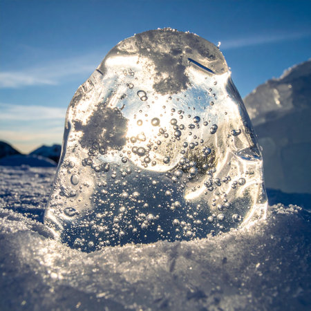 Ancient air, trapped for centuries within a glacial ice chunk, is illuminated by the low arctic sun.の素材