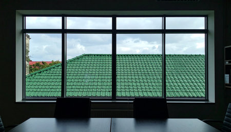 From the quiet solitude of a dimly lit meeting room, the world outside presents a simple, structured view.の素材