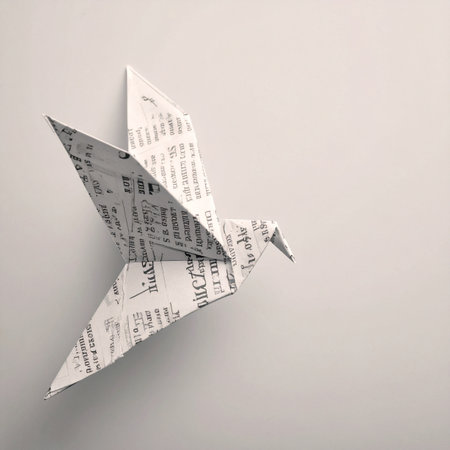 An origami dove, meticulously folded from a newspaper page filled with text and musical notes, takes flight against a simple background.の素材