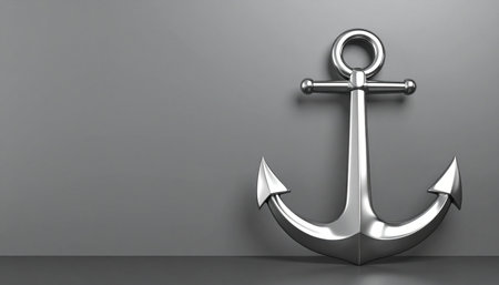 A gleaming silver anchor stands firm against a neutral grey background, a powerful metaphor for stability, security, and unwavering strength.の素材
