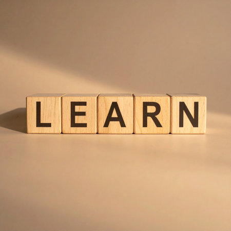Wooden blocks arranged on a clean surface spell out the word 'Learn,' symbolizing the fundamental building blocks of education and personal development.の素材