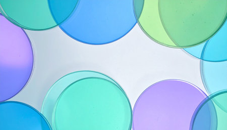 A serene composition of overlapping, translucent circles in cool shades of blue, green, and purple.の素材