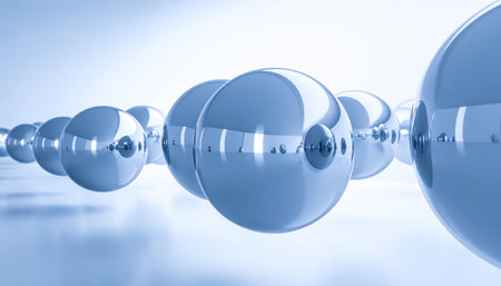 A row of perfectly polished blue spheres reflects a bright, clean environment, suggesting concepts of future technology, scientific precision, and interconnected data networks.の素材