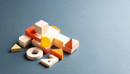 A vibrant collection of wooden geometric shapes lies ready for assembly.の素材