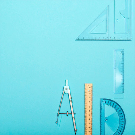 A collection of essential geometry tools laid out on a clean blue background, ready for the next big project.の素材