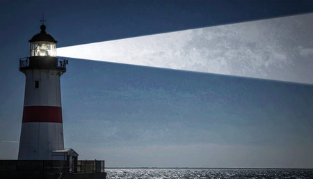 A steadfast lighthouse cuts through the deep blue twilight, its powerful beam of light providing a beacon of hope and safe passage for ships navigating the dark, open sea.の素材