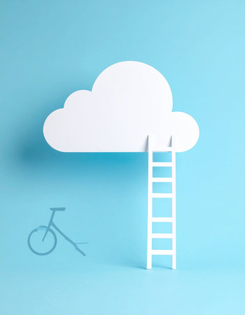 A paper ladder leans against a fluffy white cloud, symbolizing the climb towards one's goals and aspirations.の素材