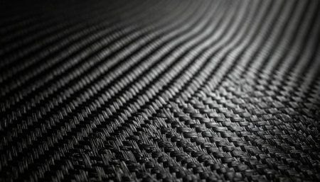 A macro perspective reveals the intricate and precise weave of a high-performance carbon fiber composite.の素材