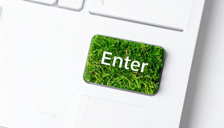 Pressing the grass-covered 'Enter' key on a modern white keyboard symbolizes a commitment to a sustainable future.の素材