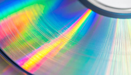 A macro view captures the mesmerizing dance of light across the surface of a compact disc.の素材