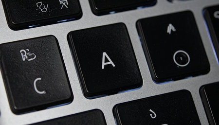 A detailed macro shot of a sleek, modern computer keyboard, with the letter 'A' key in sharp focus.の素材