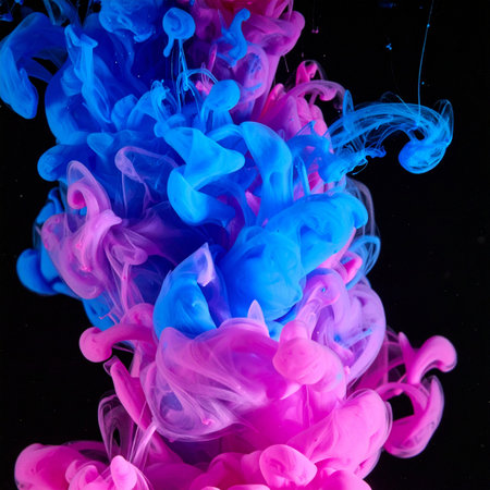 A vibrant explosion of blue and pink ink collides in dark water, creating a dynamic and ethereal cloud.の素材