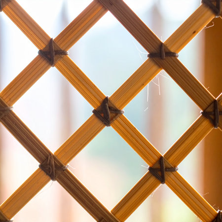 Soft morning light filters through a beautifully handcrafted bamboo lattice, creating a warm and peaceful atmosphere.の素材