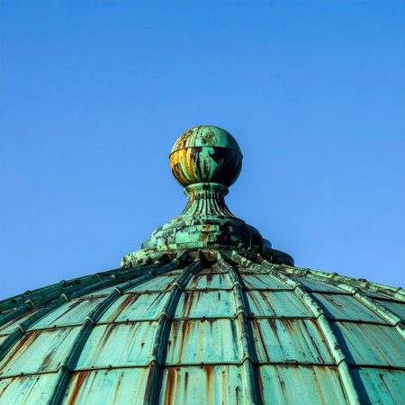 A testament to time, this historic copper dome stands proudly against a clear blue sky.の素材