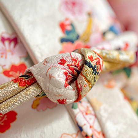 A detailed macro shot captures the intricate beauty of an obijime knot, a central element of traditional Japanese kimono attire.の素材