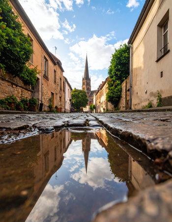 A low-angle view captures a magical moment on a historic cobblestone street.の素材