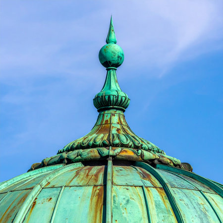 A close-up view of an ornate copper finial, crowned with a rich green patina from years of exposure to the elements.の素材