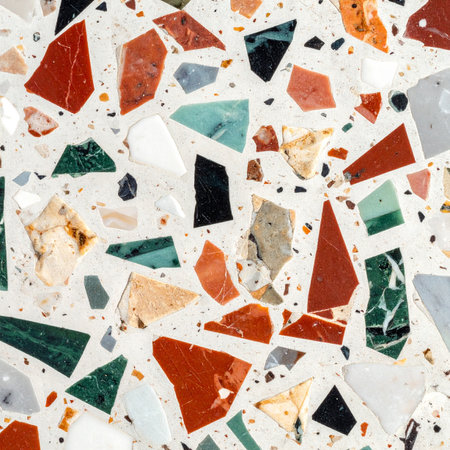 A dynamic and playful mosaic of colorful stone chips embedded in a clean white surface.の素材