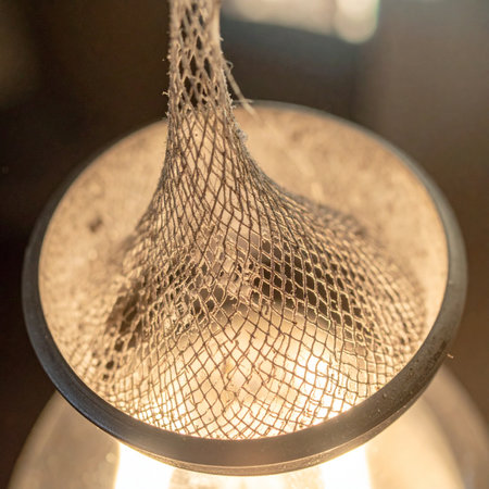 A macro photograph captures the intricate details of a modern light fixture.の素材