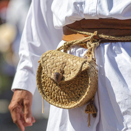 A close-up view captures the intricate detail of a handcrafted woven pouch, a testament to traditional artisan skills.の素材