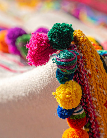 A close-up detail of a soft, handcrafted textile brings a burst of cheerful color and playful texture.の素材