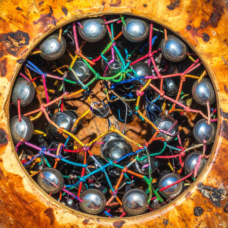 A vibrant and chaotic web of colorful wires connects a series of metallic spheres, representing a complex system of data, communication, or a neural network.の素材