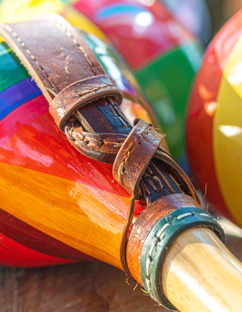 A close-up reveals the vibrant, handcrafted detail of traditional maracas.の素材