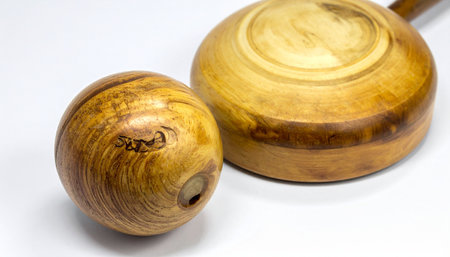 A close-up of a classic wooden golf club and ball, showcasing the rich grain and timeless craftsmanship of vintage sporting equipment.の素材