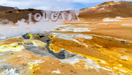 Vibrant yellow sulfur deposits and mineral-rich soil surround steaming fumaroles in Iceland's otherworldly geothermal landscape.の素材