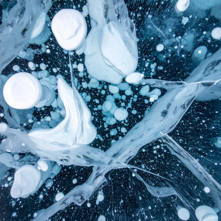 A mesmerizing macro photograph capturing the natural phenomenon of methane gas bubbles trapped within the deep, dark blue ice of a frozen lake.の素材