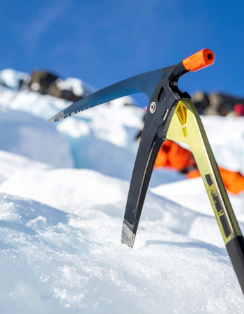 Mountaineering equipment on the snow with blue sky in the backgroundの素材