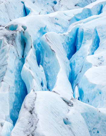 Journey into the heart of a glacier with this intimate close-up. Ancient, compressed ice glows with a deep blue light, revealing layers of time and pressure.の素材