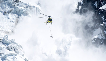 A specialized helicopter hovers precariously amidst a thundering cloud of snow, executing a high-stakes operation in the treacherous, frozen peaks.の素材
