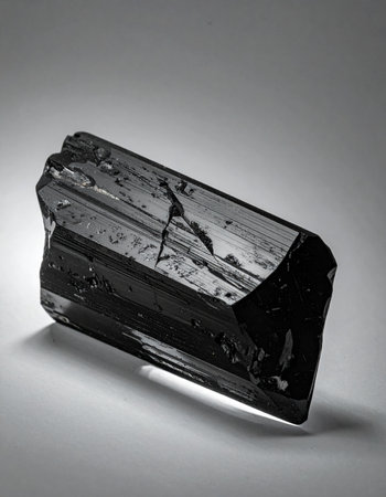 Captured in stark black and white, this raw black tourmaline crystal reveals its powerful, protective essence.の素材