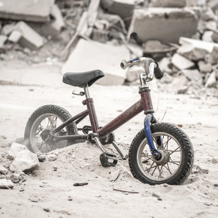 A single child's bicycle stands silently amidst the rubble of a forgotten place.の素材