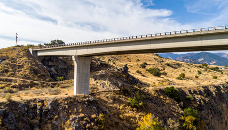 A modern marvel of engineering, this concrete highway bridge provides a vital connection across a rugged and arid canyon.の素材