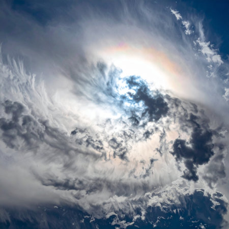 From a breathtaking high-altitude perspective, the sun bursts through a vortex of swirling clouds, illuminating the Earths atmosphere with a divine, almost painterly light. This powerful and majestic scene evokes a sense of awe, wonder, and the immense beauty of our planets weather systems.の素材