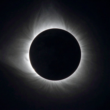 In the profound silence of space, the moon perfectly aligns with the sun, plunging the world into a momentary twilight. A breathtaking, ethereal corona of light bursts forth from the darkness, revealing the suns hidden majesty. This rare celestial event captures a moment of cosmic wonder and awe.の素材