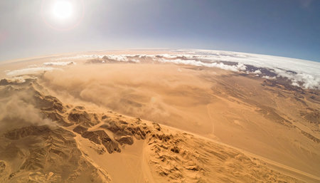 An awe-inspiring view from the stratosphere, capturing the distinct curvature of the Earth. Below, a vast, sun-drenched desert stretches to the horizon, its rugged terrain meeting the thin, delicate layer of the atmosphere. This is a perspective of solitude, exploration, and the breathtaking beauty of our planet from the edge of space.の素材