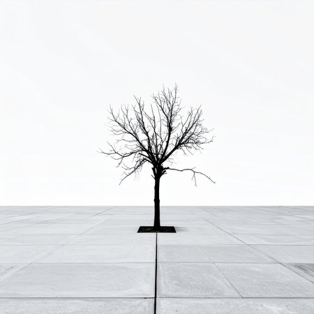 In a vast, sterile plaza of white and grey, a single bare tree stands as a stark silhouette. This powerful minimalist image evokes feelings of solitude, resilience, and the quiet strength of nature persisting within a modern, abstract urban landscape. A symbol of survival and hope against a clean, empty backdrop.の素材