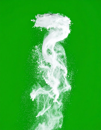 A powerful burst of white particles erupts and swirls against a vibrant green screen background. This dynamic and abstract visual element is perfect for creating compelling special effects, representing concepts of energy, creation, or magical phenomena in post-production.の素材