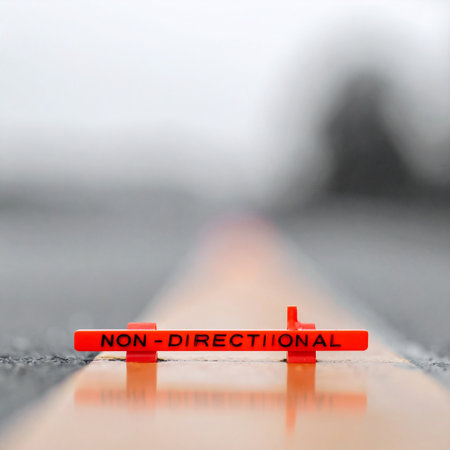 A small orange marker labeled non-directional sits on a line, symbolizing a moment of choice without a clear path forward. This conceptual image represents ambiguity, freedom, and the strategic decisions faced in business and life, with a blurred background focusing on the decision point.の素材