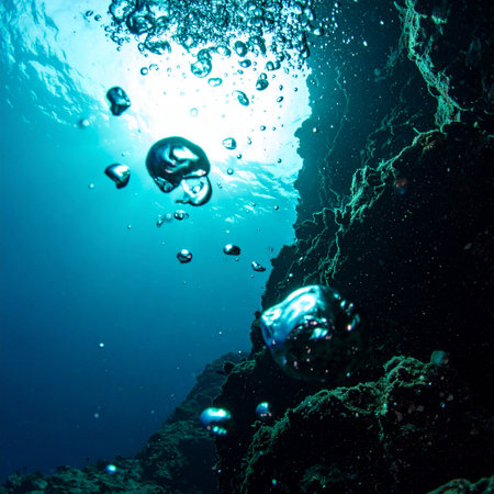 From the unseen depths, shimmering spheres of air begin their silent ascent. They travel through the deep blue, past ancient rock formations, on a journey towards the life-giving light of the sun-drenched surface. A moment of tranquility and hope captured in the vastness of the ocean.の素材