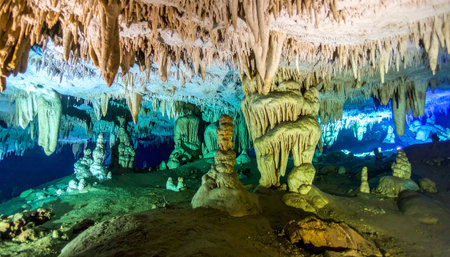 Step into a hidden world beneath the earths surface, where ancient stalactites and stalagmites are brought to life by vibrant, colorful lights. This breathtaking subterranean landscape evokes a sense of mystery, adventure, and the timeless beauty of geological wonders.の素材